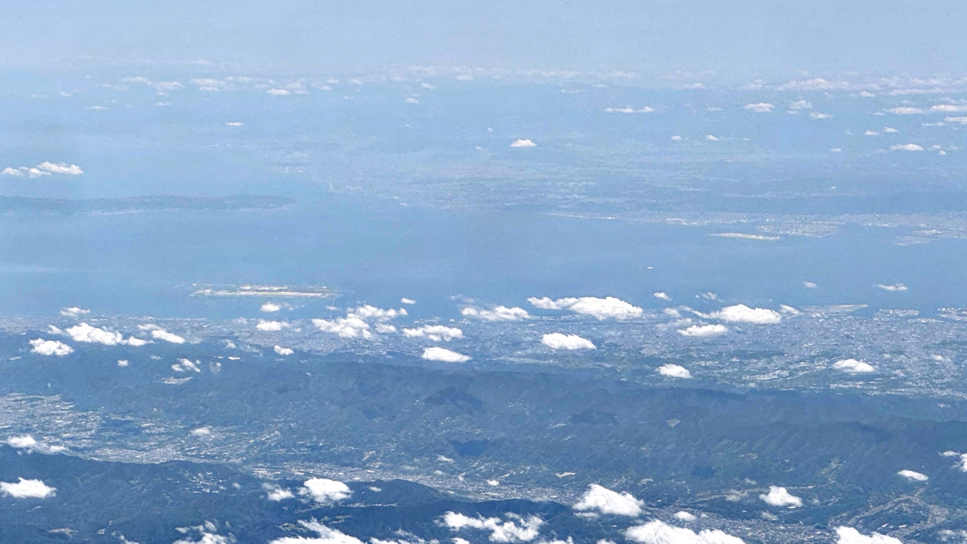 Beim Flug über die Halbinsel Kii in der Präfektur Wakayama ist in der Ferne die Bucht von Osaka mit den Flughäfen Kansai und Kobe zu erkennen.